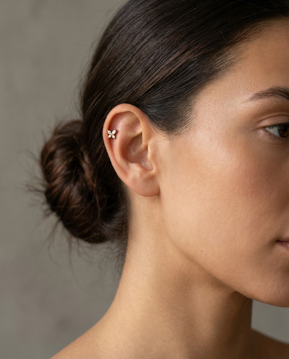 Billie sommerfuglepiercing med flat back og push pin i guld på øre